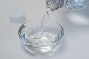 vinegar being poured to clean washing machine from being smelly